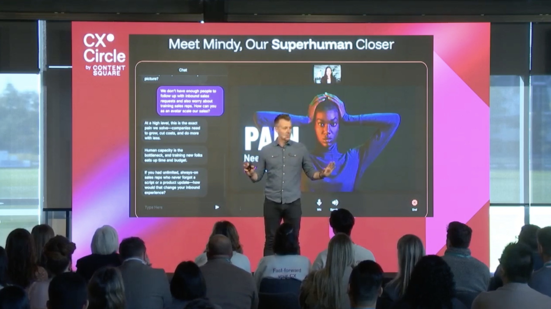 Dave Anderson on stage at CX Circle, presenting an AI sales agent demo
